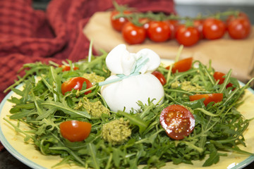 Tasty salad with burrata cheese and tomatoes