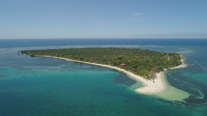 Tropical island with white sandy beach. Aerial view: Magalawa island with colorful reef. Seascape, ocean and beautiful beach paradise. Philippines,Luzon. Travel concept.