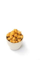 popcorn with caramel in white tiled cup isolated on white background.
