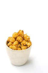 popcorn with caramel in white tiled cup isolated on white background.