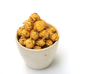 popcorn with caramel in white tiled cup isolated on white background.