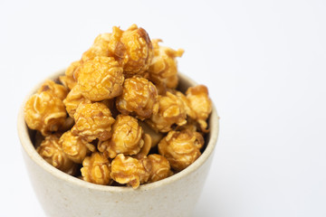 popcorn with caramel in white tiled cup isolated on white background.