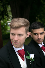 Gay couple of grooms pose for photographs on their wedding day