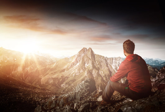 Mountaineer looking over mountain sunrise scene