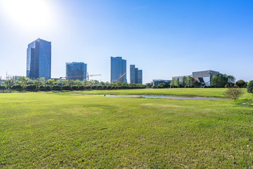 Obraz premium modern office building with green lawn in park