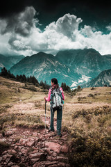 Young woman backpacking in the mountains