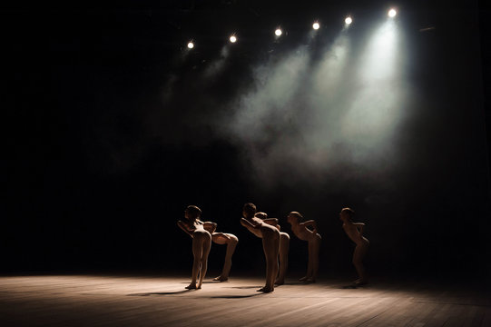A Group Of Small Ballet Dancers Rehearses On Stage With Light And Smoke