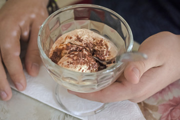 ice creme brulee cream in a glass cup in hands