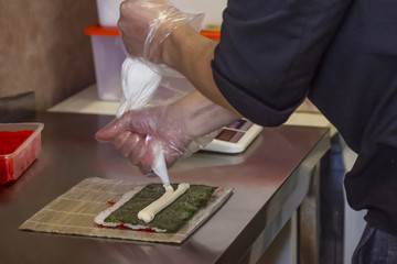 process of creating rolls with fish caviar
