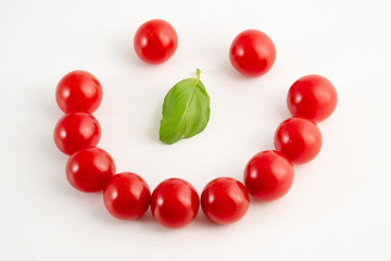 Smile face made from tomatoes and basil
