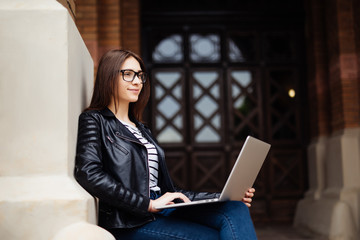 Prepering for exam. Young student on university campus with computer laptop