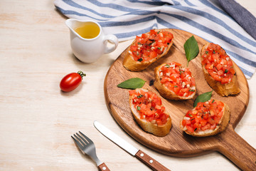 Simple italian appetizing bruschetta with tomato, on wooden table