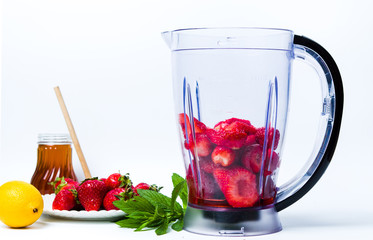 Strawberry smoothie ingredients in a blender