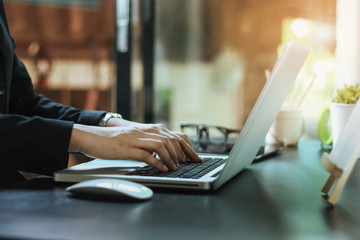 businesswoman and thinking in front of laptop while sitting at working space office to manage her coffee shop.Small business pondering over ideas for new business project,vintage tone