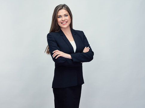 smiling business woman wearing black suit standing with crossed
