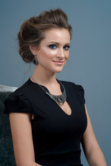 Fototapeta premium fashion woman with creative make-up and hairstyle wearing and jewelry. The beauty of the face.