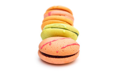 Row of macaroons on white background.