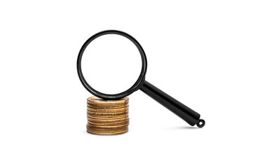 Magnifying glass on the stack of coins on white background.
