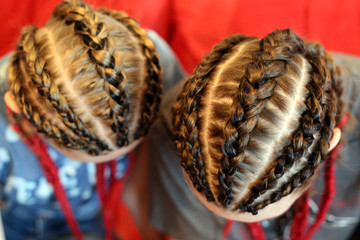 four braids, five thick plaits, a youth hairstyle with a kanekalon, artificial colored hair used in braiding, woven, hair extension method of pigtail