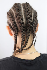 four braids, five thick plaits, a youth hairstyle with a kanekalon, artificial colored hair used in braiding, woven, hair extension method of pigtail