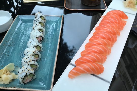 Sushi with salmon on the table with reflection. California.