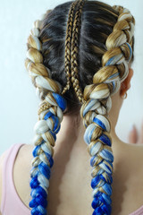 creative hairstyle of two braids with vpoyeniem blue kanekalona, very thick pigtails with a decor of thin plaits