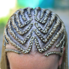 Close-up of hair braided in pigtails, girl's head, blonde hair, thin, tight, youth style