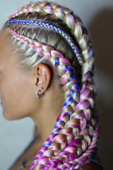 a beautiful hairstyle made of thick and thin braid on the head with a colored kanekalon, hair is...