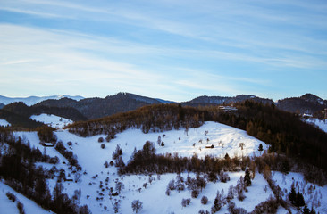 Panoramic Transylvanian landscape from mountains tiny houses and forests in the morning