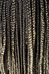 texture of thin African braids classic hairstyle African American, European hair, blond, girls with white skin, close-up hairstyle, pigtails in details