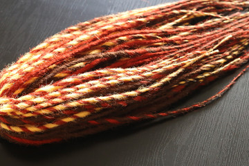 dreadlocks, blanks for weaving in hair, hairstyle of rastamans, masters braiding hair in braids, materials for handmade weaving close-up