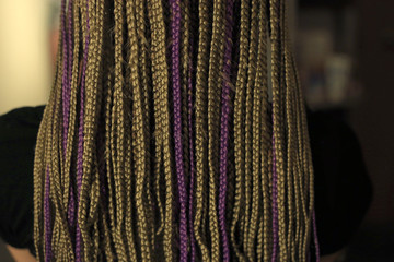 texture of thin African braids classic hairstyle African American, European hair, blond, girls with white skin, close-up hairstyle, pigtails in details