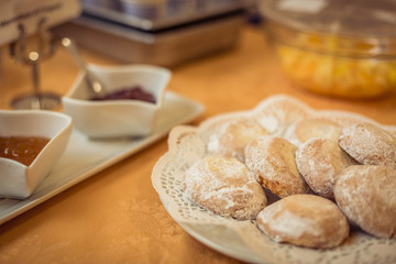 Breakfast. Close-up of traditional Sicilian sweets (cassatelle) and two bowls with jam on the table