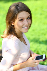 Fototapeta premium Young woman reading a message on a cell phone