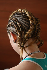 hairstyles from thin plaits on the head of a girl, a master, a beauty salon, a beauty trail