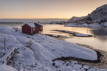 Wooden tourist cabin on nordic winter coast in Lofoten with beautiful sea view