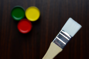 The brush is on the table with gouache