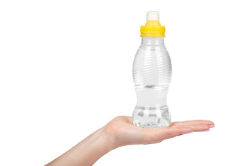 Transparent water bottle with yellow cap and hand isolated on white background