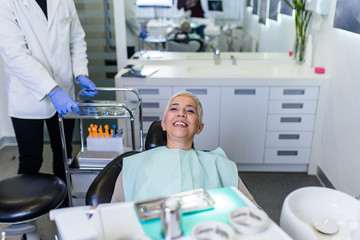 Obraz premium Beautiful senior woman having dental treatment at dentist's office.