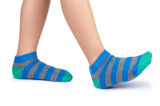 Kid Legs In Striped Socks Isolated On White Background