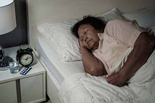 senior woman sleeping in bed at night