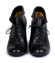 Female black leather high heel shoes isolated on white background