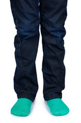 Kid legs in colored socks on leg isolated on white background