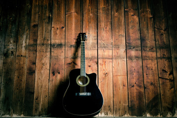 Acoustic guitar on a wooden texture with copy space for a text. Music and leisure concept. Guitar...