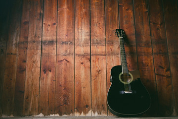 Acoustic guitar on a wooden texture with copy space for a text. Music and leisure concept. Guitar...