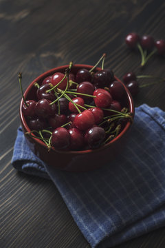 Cherries. Cherry. Cherries in color bowl and kitchen napkin.