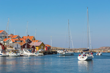 Fototapeta na wymiar Sailboat heading out to sea from the marina in Grundsund on the Swedish west coast