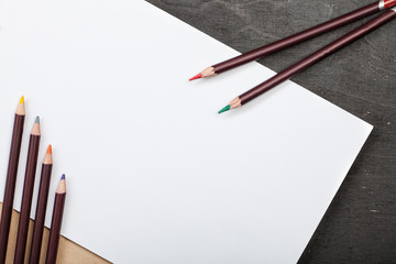 lot of colored pencils and drawing paper