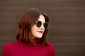 Fototapeta premium Autumn sunny lifestyle fashion portrait of young stylish hipster woman walking on the street.