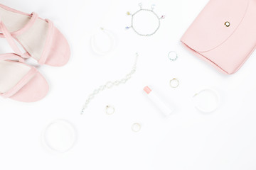 Fashion accessories, make up products, sandals and handbag on white background. Beauty and fashion concept, flat lay